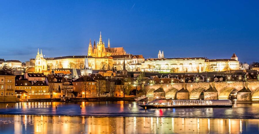Prague Castle and Charles Bridge lit above the Vltava