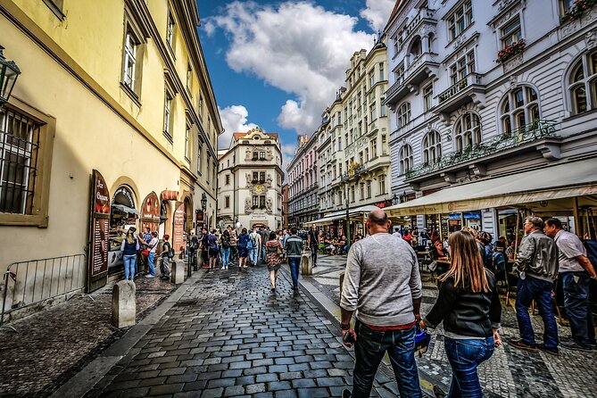 Prague DeLuxe Tour: Views, Hidden Gems, Tastings & River Cruise - Crossing Charles Bridge into Lesser Town