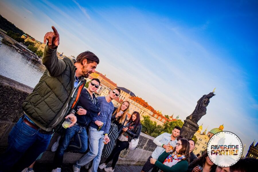 Prague Riverside Parties Tour - Crossing Charles Bridge with drinks and music