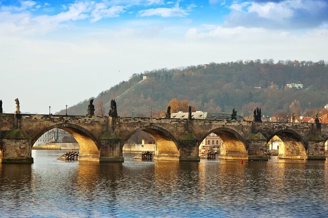 Private Guided Alternative Historical Electric Bike Tour - Seeing Charles Bridge from the riverbank